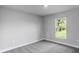 Spacious bedroom with grey carpet and large window at 8136 Welsford Rd, Port Charlotte, FL 33981