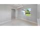 Bright dining room with large window and modern chandelier at 8136 Welsford Rd, Port Charlotte, FL 33981