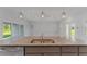 Modern kitchen features granite countertops, stainless steel sink, and pendant lighting at 8136 Welsford Rd, Port Charlotte, FL 33981