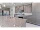 Modern kitchen with gray cabinets and granite countertops at 8136 Welsford Rd, Port Charlotte, FL 33981