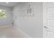 Laundry room with shelving and a white door at 8136 Welsford Rd, Port Charlotte, FL 33981