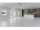 Open living room and kitchen with tile flooring and high ceilings at 8136 Welsford Rd, Port Charlotte, FL 33981