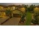 Evening view of townhouse with a two-car garage and landscaping at 12510 Ghiberti Cir # 102, Venice, FL 34293