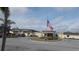 Exterior view of a building with a flag at 5787 Holiday Park Blvd, North Port, FL 34287