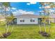 Home with a screened patio and grassy backyard at 16423 Bridle Ridge St, Port Charlotte, FL 33953