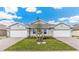 Attractive exterior of a newly built home with two-car garage and landscaping at 16423 Bridle Ridge St, Port Charlotte, FL 33953