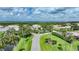 Community entrance with palm trees and lush green landscaping at 3332 Grand Vista Ct # 101, Port Charlotte, FL 33953