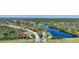Community entrance with lush landscaping and lake at 3332 Grand Vista Ct # 101, Port Charlotte, FL 33953