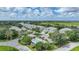 Aerial view of community with pool, lush landscaping, and waterfront access at 3332 Grand Vista Ct # 101, Port Charlotte, FL 33953