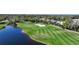 Aerial view of golf course with pond and meticulously manicured greens at 3332 Grand Vista Ct # 101, Port Charlotte, FL 33953