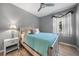 Cozy bedroom featuring light wood flooring and a ceiling fan at 3332 Grand Vista Ct # 101, Port Charlotte, FL 33953