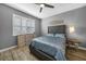 Comfortable bedroom with dresser, light blue bedding, and window shutters at 3332 Grand Vista Ct # 101, Port Charlotte, FL 33953