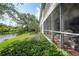 Back exterior showcasing a screened porch and lake view at 3332 Grand Vista Ct # 101, Port Charlotte, FL 33953