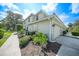 Exterior view of a condo unit, showcasing attached garage and landscaping at 3332 Grand Vista Ct # 101, Port Charlotte, FL 33953