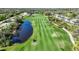 Golf course with pond and player on the green at 3332 Grand Vista Ct # 101, Port Charlotte, FL 33953