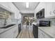 Bright kitchen with white cabinets, modern appliances, and view to dining area at 3332 Grand Vista Ct # 101, Port Charlotte, FL 33953