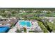 Community pool with lap lanes, lounge chairs, and surrounding landscaping at 3332 Grand Vista Ct # 101, Port Charlotte, FL 33953