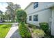 Landscaped side yard with walkway leading to condo at 3332 Grand Vista Ct # 101, Port Charlotte, FL 33953
