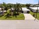 Aerial view of a waterfront home with private dock and lush landscaping at 18598 Briggs Cir, Port Charlotte, FL 33948