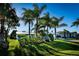 Landscaped front yard of a single-story home with palm trees at 18598 Briggs Cir, Port Charlotte, FL 33948