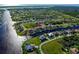 High aerial showing convenient canal access, homes, and neighborhood in the distance at 9310 Rosebud Cir, Port Charlotte, FL 33981