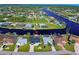 Aerial view of waterfront homes along a canal, showcasing community and waterfront lifestyle at 9310 Rosebud Cir, Port Charlotte, FL 33981