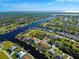 Wide aerial shot of property featuring the canal, local neighborhood and access to the Gulf at 9310 Rosebud Cir, Port Charlotte, FL 33981