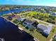 Aerial view of property highlighting landscaping and proximity to the canal in quiet neighborhood at 9310 Rosebud Cir, Port Charlotte, FL 33981