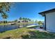 View of the backyard showing waterfront access, boat lift, and canal at 9310 Rosebud Cir, Port Charlotte, FL 33981