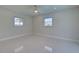 Bright bedroom with tile floors, ceiling fan, and dual windows, offers a relaxing space to unwind and recharge at 9310 Rosebud Cir, Port Charlotte, FL 33981