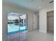 Bright bedroom with marble floors, ceiling fan, closet, and pool access at 9310 Rosebud Cir, Port Charlotte, FL 33981