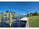 Waterfront view of a dock and boat lift on a canal with tropical landscaping at 9310 Rosebud Cir, Port Charlotte, FL 33981