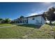Exterior view of home, showing the screened in pool and canalside backyard at 9310 Rosebud Cir, Port Charlotte, FL 33981