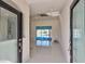 View of the foyer with decorative glass doors leading into a bright, marble-floored home at 9310 Rosebud Cir, Port Charlotte, FL 33981