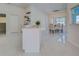 Bright kitchen features white cabinets, stainless steel appliances, and an adjacent dining area, great for entertaining at 9310 Rosebud Cir, Port Charlotte, FL 33981
