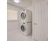 Efficient laundry room features stacked washer and dryer, and a convenient location near the bedrooms, providing ease of use at 9310 Rosebud Cir, Port Charlotte, FL 33981