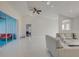 Bright living room boasts an open floor plan, vaulted ceilings, ceiling fan and access to the outdoor patio at 9310 Rosebud Cir, Port Charlotte, FL 33981