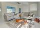Bright living room with neutral modern furniture, vaulted ceilings, and marble floors at 9310 Rosebud Cir, Port Charlotte, FL 33981