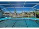 Covered outdoor pool offering a clear, relaxing space for fun and leisure with canal views at 9310 Rosebud Cir, Port Charlotte, FL 33981
