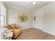 Bedroom with hardwood floors, light walls, and a comfortable chair at 611 W Olympia Ave, Punta Gorda, FL 33950
