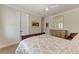 Bright bedroom features hardwood floors, light walls, and a comfortable chair at 611 W Olympia Ave, Punta Gorda, FL 33950