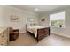 Bright bedroom features hardwood floors, light walls, window and a comfortable chair at 611 W Olympia Ave, Punta Gorda, FL 33950