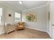 Bedroom with hardwood floors, light walls, and a comfortable chair at 611 W Olympia Ave, Punta Gorda, FL 33950