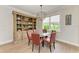 Dining room features a glass table with seating for five and custom built-in shelving at 611 W Olympia Ave, Punta Gorda, FL 33950