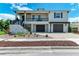 Exterior elevation of home featuring a large front porch, two-car garage, and manicured landscaping at 611 W Olympia Ave, Punta Gorda, FL 33950