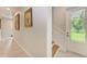 Hallway showcasing tile flooring, artwork on the walls and staircase leading up to the second level at 611 W Olympia Ave, Punta Gorda, FL 33950