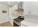 Kitchen features stainless steel appliances, white cabinetry, and a subway tile backsplash at 611 W Olympia Ave, Punta Gorda, FL 33950