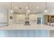 Bright kitchen features a large center island with a stainless steel sink, modern appliances and pendant lighting at 611 W Olympia Ave, Punta Gorda, FL 33950
