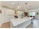 Large kitchen island with stainless steel appliances, a breakfast bar, and an open dining area at 611 W Olympia Ave, Punta Gorda, FL 33950