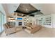 Spacious living room with fireplace, built-in bookshelves, and hardwood floors at 611 W Olympia Ave, Punta Gorda, FL 33950